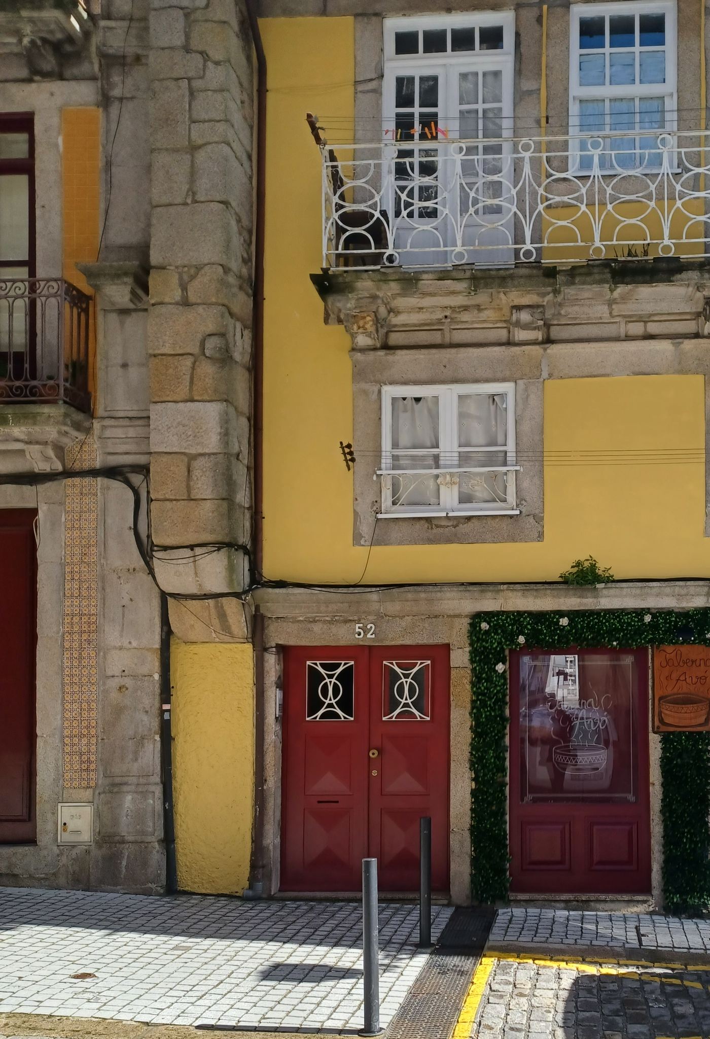Historic building façade with the red door of number 52, Rua de São Bento da Vitória