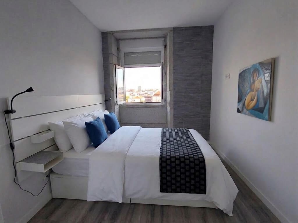 Main bedroom with window and view over the historic centre rooftops